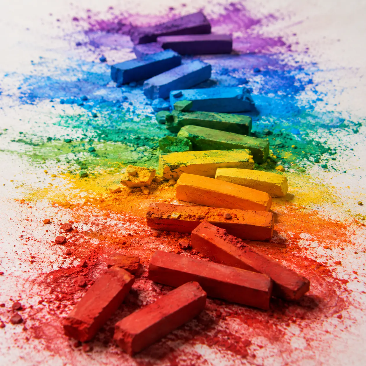 Broken soft pastels scattered across a burst of pigment